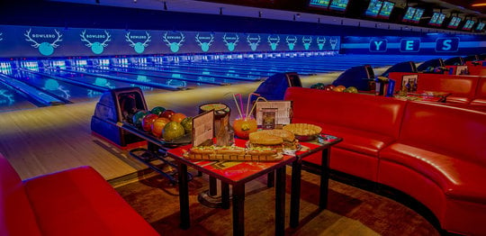 Seating and lanes with food and drinks on table