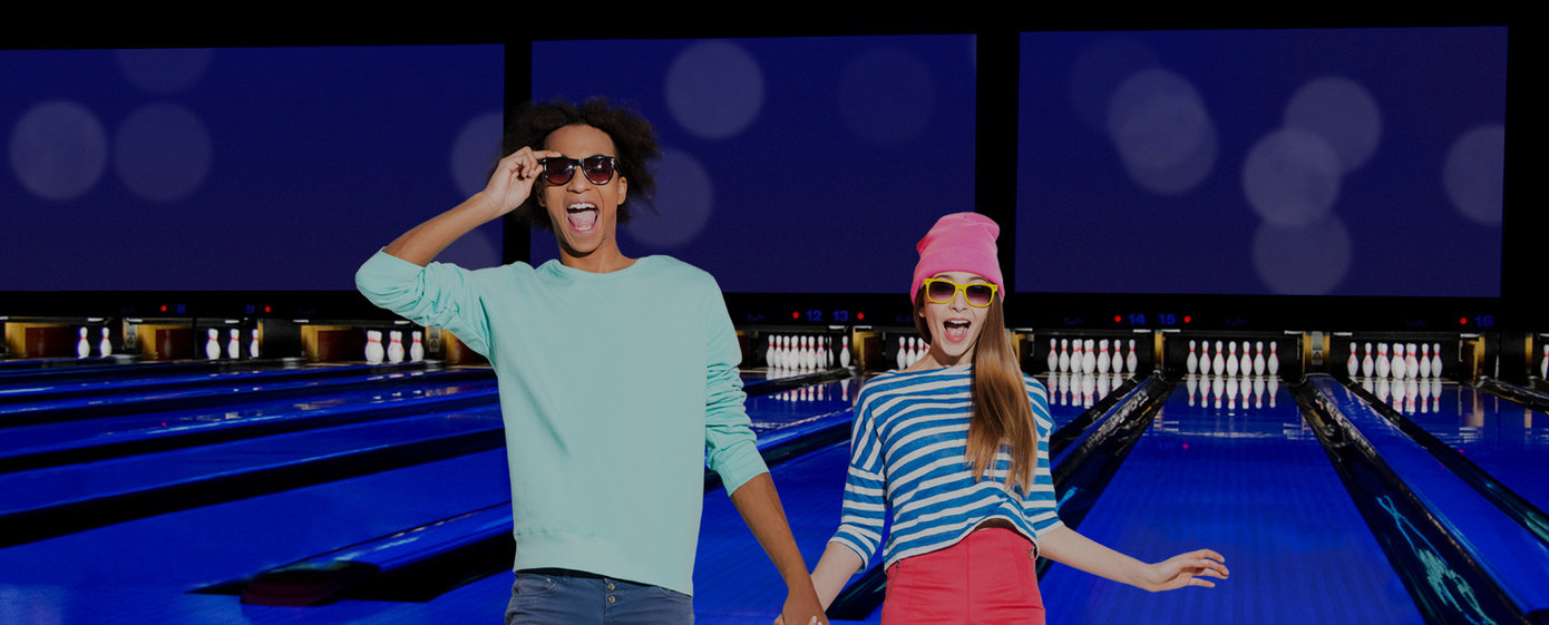 teens holding hands jumping on lanes