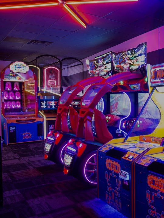 neon lit arcade games in a row