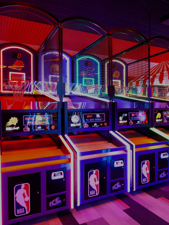 neon lit arcade games in a row