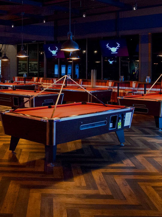Multiple red billiards tables