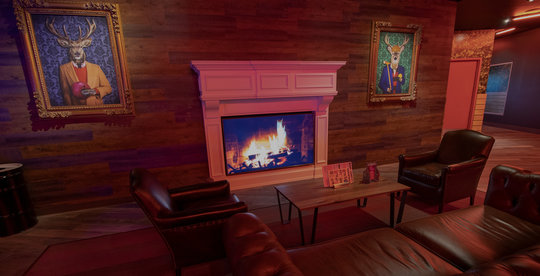 lounge area with a fireplace and pictures on the walls