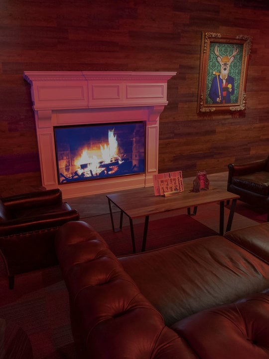 lounge area with a fireplace and pictures on the walls