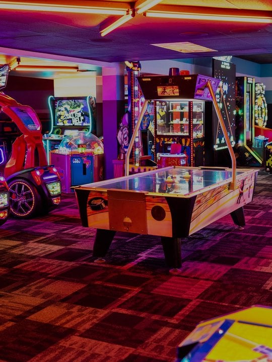 view of arcade and air hockey table