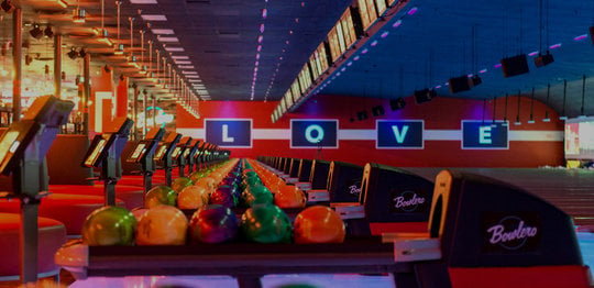 Ball returns and bowling lanes with 'LOVE' written on the wall
