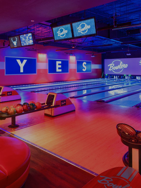 image of bowling lanes facing the pins, with 'y - e - s' written on the wall