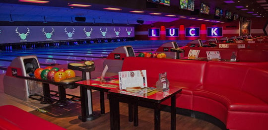 Red plush couches and lanes at Bowlero San Marcos