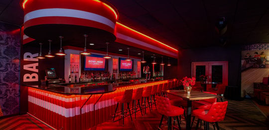 bar area with neon lighting and tables