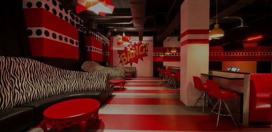 Pop Art lounge and lanes. Zebra print couches and red chairs and walls.