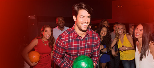 Man holding a green bowling ball