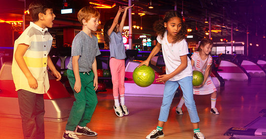 group of kids bowling on the lanes